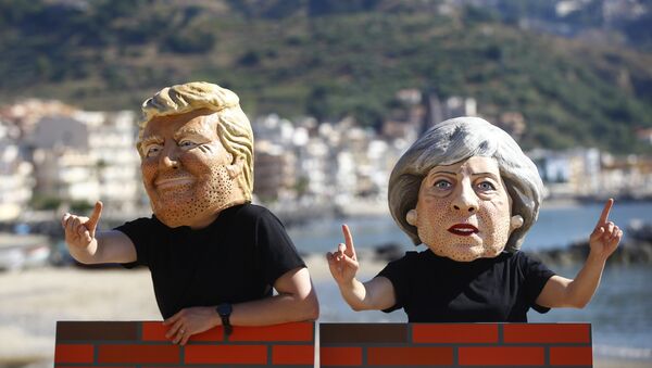 Protesters wear masks depicting U.S. President Donald Trump and Britain's Prime Minister Theresa May during a demonstration against a G7 summit organised by Oxfam in Giardini Naxos near Taormina, Sicily, Italy, May 27, 2017. - Sputnik International