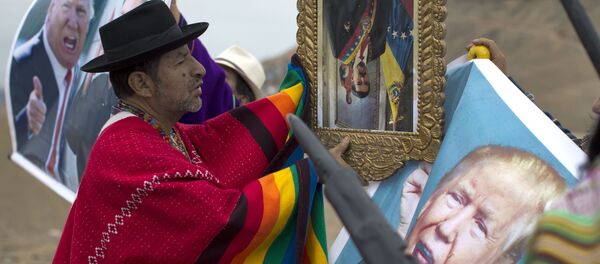 A shaman performs a ceremony holding a portrait of Venezuela's President Nicolas Maduro upside down, as another holds a poster of U.S. President Donald Trump, on Morro Solar in Lima, Peru, Monday, June 12, 2017 A shaman performs a ceremony holding a portrait of Venezuela's President Nicolas Maduro upside down, as another holds a poster of U.S. President Donald Trump, on Morro Solar in Lima, Peru, Monday, June 12, 2017 - Sputnik International