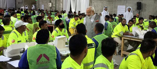 In this Saturday June 4, 2016 photo released by the Indian Prime Minister's Tweeter, Indian Prime Minister Narendra Modi, center, meets with hundreds of Indian laborers at a workers' camp in the capital Doha, Qatar In this Saturday June 4, 2016 photo released by the Indian Prime Minister's Tweeter, Indian Prime Minister Narendra Modi, center, meets with hundreds of Indian laborers at a workers' camp in the capital Doha, Qatar - Sputnik International