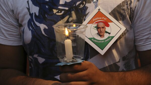 An Indian man holds a candle as he participates in a demonstration in support of Indian naval officer Kulbhushan Jadhav in Mumbai, India, Saturday, June 03, 2017 - Sputnik International