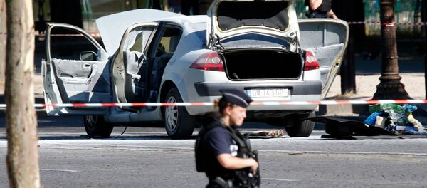 Police secure the area near a burned car at the scene of an incident in which it rammed a gendarmerie van on the Champs-Elysees Avenue in Paris, France, June 19, 2017 - Sputnik International