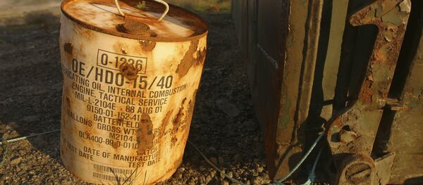 Rusty container of lubricant oil for a U.S. military vehicle stands among abandoned U.S. military material on Aug. 16, 2005, outside the eastern Greenland settlement of Kulusuk where there used to be an U.S. Air Force base as part of an early warning radar system (File) - Sputnik International