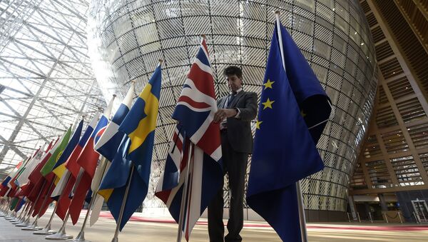 An organiser adjusts the British national flag on April 29, 2017, prior to the EU leaders summit at the Europa building, the main headquarters of European Council and the Council of the EU, in Brussels - Sputnik International