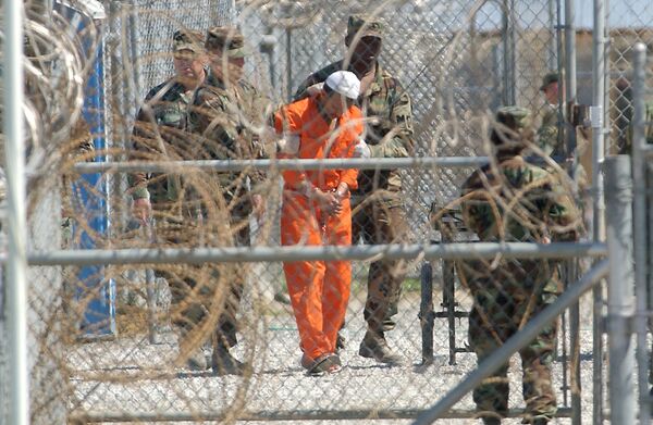 A detainee from Afghanistan is led by military police with his hands chained at Camp X-Ray at the U.S. Naval Base in Guantanamo Bay, Cuba, in this Feb. 2, 2002, file photo A detainee from Afghanistan is led by military police with his hands chained at Camp X-Ray at the U.S. Naval Base in Guantanamo Bay, Cuba, in this Feb. 2, 2002, file photo - Sputnik International
