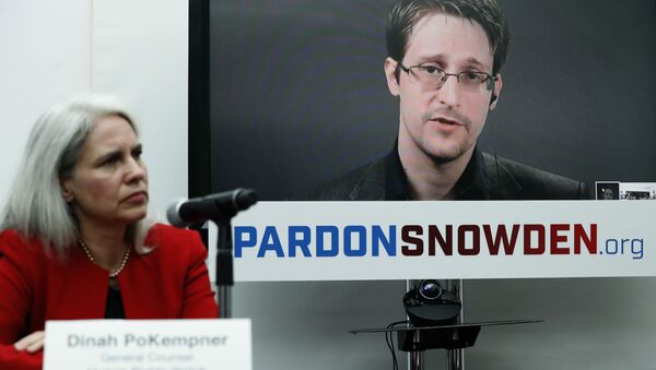 Dinah PoKempner, left, general council for Human Rights Watch, listens as Edward Snowden speaks on a television screen via video link from Moscow during a news conference to call upon President Barack Obama to pardon Snowden before he leaves office, Wednesday, Sept. 14, 2016, in New York. - Sputnik International