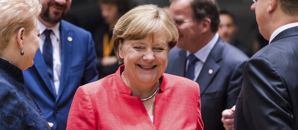 German Chancellor Angela Merkel, center, smiles as she attends a round table meeting at an EU Summit in Brussels on Friday, June 23, 2017. - Sputnik International