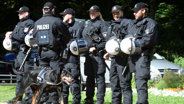 A dog passes a row of police men during a G20 demonstration against the ban of Hamburg's authorities of a G20 protestors camp in the Stadtpark park in Hamburg, Germany June 26, 2017 - Sputnik International