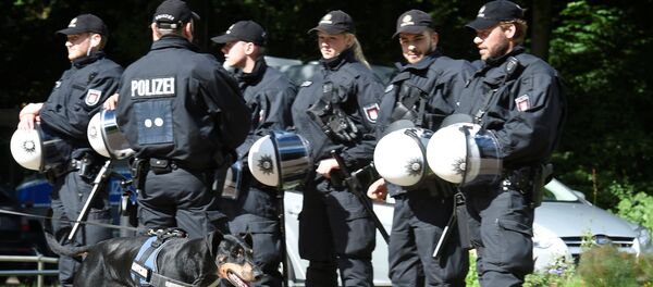 A dog passes a row of police men during a G20 demonstration against the ban of Hamburg's authorities of a G20 protestors camp in the Stadtpark park in Hamburg, Germany June 26, 2017 - Sputnik International