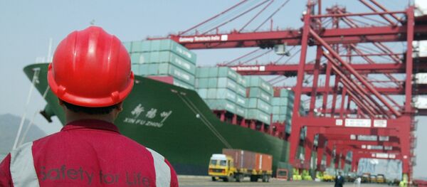 A worker watches operations at the container off-loading terminal in the Jawaharlal Nehru Port Trust (JNPT) premises in Mumbai (File) A worker watches operations at the container off-loading terminal in the Jawaharlal Nehru Port Trust (JNPT) premises in Mumbai (File) - Sputnik International