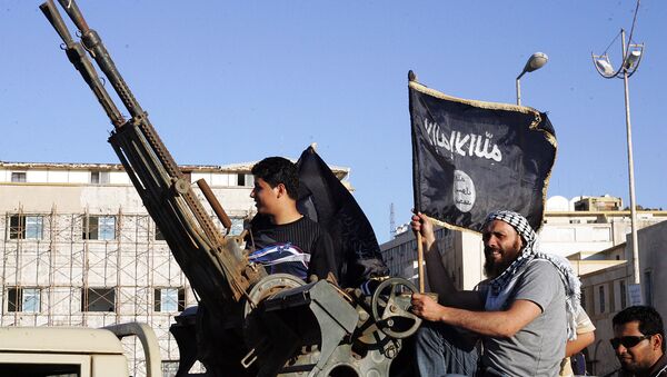 Libyan men hold Al-Qaeda flags while sitting next to an anti-aircraft artillery weapon (File) - Sputnik International