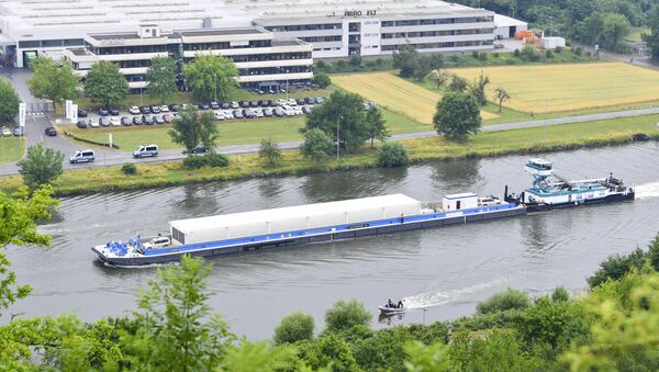 The push boat 'Edda' pushes the transport ship loaded with three Castor containers with nuclear waste on the Neckar river in Obrigheim, Germany, Wednesday, June 28, 2017. The containers will be transported to the interim storage in Neckarwestheim. It is the first nuclear waste transport across a river containing highly radioactive waste. - Sputnik International