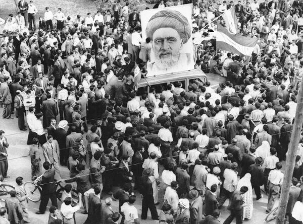 In this Dec. 13, 1951 file photo, crowds of supporters of Prime Minister Mossadegh gather around a huge portrait of Iranian Mullah Kashani, one of the powerful backers of Mossadegh's regime, in Tehran. Once expunged from its official history, documents outlining the U.S.-backed 1953 coup in Iran have been quietly published in June 2017, by the State Department, offering a new glimpse at an operation that ultimately pushed the country toward its 1979 Islamic Revolution and hostility with the West. In this Dec. 13, 1951 file photo, crowds of supporters of Prime Minister Mossadegh gather around a huge portrait of Iranian Mullah Kashani, one of the powerful backers of Mossadegh's regime, in Tehran. Once expunged from its official history, documents outlining the U.S.-backed 1953 coup in Iran have been quietly published in June 2017, by the State Department, offering a new glimpse at an operation that ultimately pushed the country toward its 1979 Islamic Revolution and hostility with the West. - Sputnik International