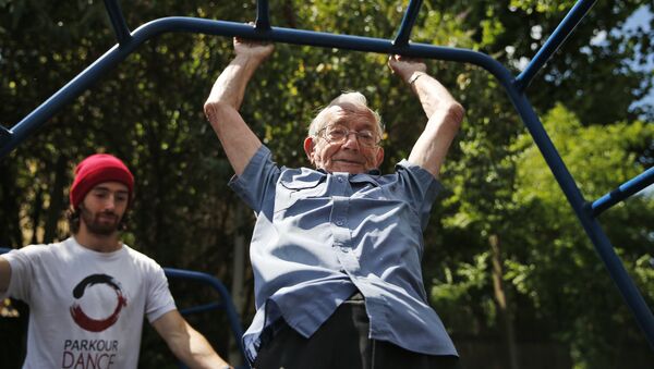 In this Tuesday, June 17, 2014 photo, George Jackson, 85, an army veteran and former boxer swings on monkey bars as he participates at a parkour class for elderly people at a park in south London - Sputnik International