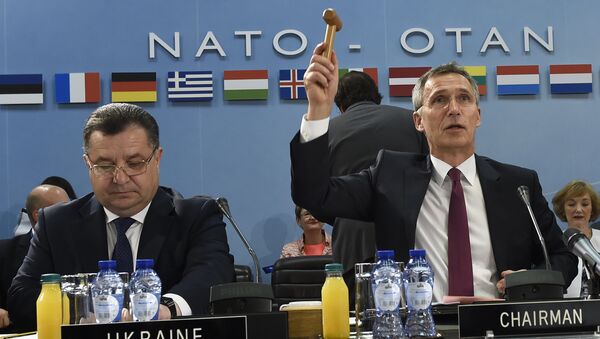 NATO Secretary-General Jens Stoltenberg (R) holds up a gavel, flanked by Ukrainian Minister of Defence and General of the Army Stepan Poltorak, during a NATO-Ukraine Defense Council meeting at the NATO Headquarters in Brussels (File) - Sputnik International