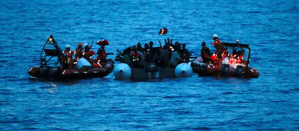 Migrants on a dinghy are rescued by Save the Children NGO crew from the ship Vos Hestia in the Mediterranean sea off Libya coast, June 17, 2017 Migrants on a dinghy are rescued by Save the Children NGO crew from the ship Vos Hestia in the Mediterranean sea off Libya coast, June 17, 2017 - Sputnik International