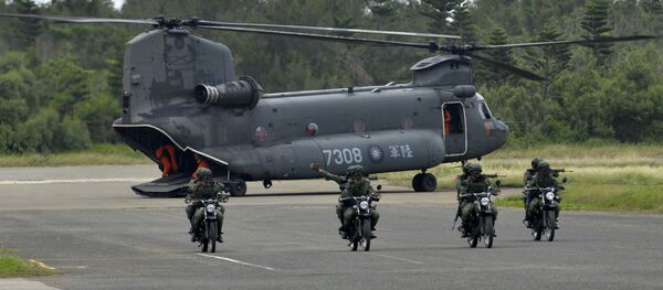 This file photo shows armed Taiwanese soldiers riding on motorcycles next to a US-made CH-47 helicopter during drills on Penghu islands This file photo shows armed Taiwanese soldiers riding on motorcycles next to a US-made CH-47 helicopter during drills on Penghu islands - Sputnik International