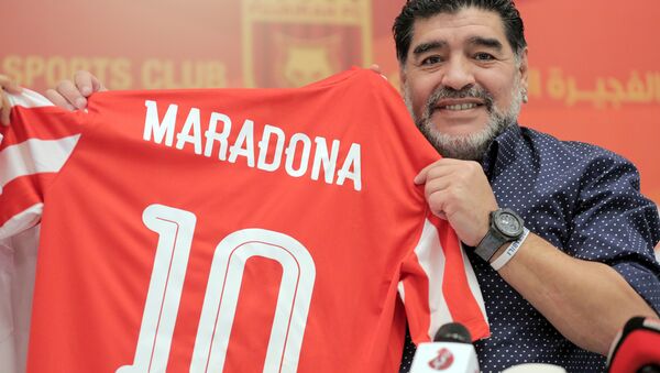 Former Argentinian footballer and manager Diego Armando Maradona holds a jersey of the football club Fujairah FC, bearing his name on the reverse, during a press conference where he was announced as the upcoming manager for the team, in the Gulf emirate of Fujairah on May 14, 2017 - Sputnik International