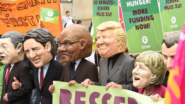 Oxfam’s Big Heads depict G20 leaders take part in protests ahead of the upcoming G20 summit in Hamburg, Germany July 2, 2017. - Sputnik International