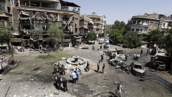 Syrians inspect the site of a suicide bomb attack in the capital Damascus' eastern Tahrir Square district, on July 2, 2017 - Sputnik International