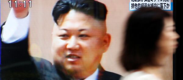 A woman walks past a street monitor in Tokyo, Japan, reporting that North Korea had fired a ballistic missile, in this photo taken by Kyodo July 4, 2017. - Sputnik International