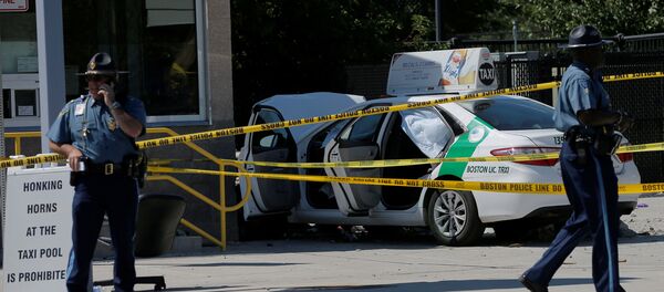 A Massachusetts State Police officer walks past the scene where a taxi cab crashed into a group of bystanders at the taxi pool at Logan International Airport in Boston, Massachusetts, U.S A Massachusetts State Police officer walks past the scene where a taxi cab crashed into a group of bystanders at the taxi pool at Logan International Airport in Boston, Massachusetts, U.S - Sputnik International