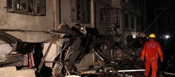 A Bangladeshi rescue worker walks through rubble and debris at a garment factory in Gazipur on July 3, 2017, after an explosion at the factory on the outskirts of Dhaka A Bangladeshi rescue worker walks through rubble and debris at a garment factory in Gazipur on July 3, 2017, after an explosion at the factory on the outskirts of Dhaka - Sputnik International
