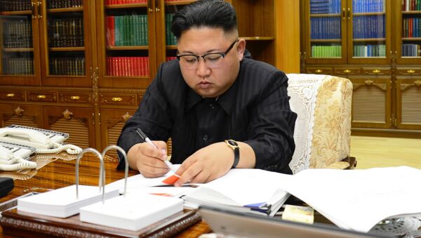 North Korean Leader Kim Jong Un signs the order to carry out the test-fire of inter-continental ballistic rocket Hwasong-14 in this undated photo released by North Korea's Korean Central News Agency (KCNA) in Pyongyang, July, 4 2017. - Sputnik International