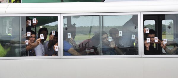 FILE - In this Aug. 2, 2013, photo, a group of asylum seekers hold up their identity after landing in Manus Island, Papua New Guinea. - Sputnik International