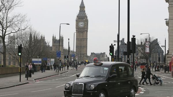 A black cab drives past as Westminster Bridge is re-opened to the public Thursday, March 23, 2017, following an attack on Wednesday when a man drove a car into pedestrians then stabbed a police officer to death before being fatally shot by police within Parliament's grounds - Sputnik International