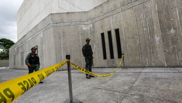 Members of the National Guard stands behind a yellow tape in the area where according to authorities grenades were thrown from a helicopter earlier this week, at the Supreme Court in Caracas on June 29, 2017 - Sputnik International