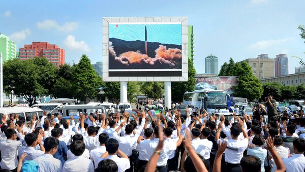 People watch a huge screen showing the test launch of intercontinental ballistic missile Hwasong-14 in this undated photo released by North Korea's Korean Central News Agency (KCNA), July 5, 2017 - Sputnik International
