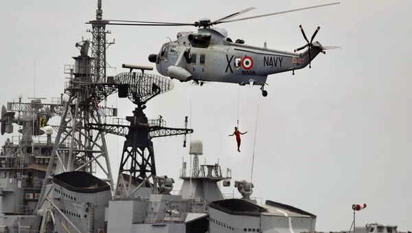 An Indian navy helicopter approaches an Indian navy ship while displaying rescue skills during a joint naval exercise with the Sri Lankan navy in Trincomalee, Sri Lanka (File) - Sputnik International