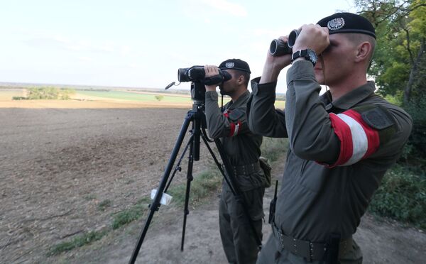 Austrian soldiers watch the border for illegally entering migrants between Hungary and Austria in Nickelsdorf, Austria, Tuesday, Sept. 20, 2016 Austrian soldiers watch the border for illegally entering migrants between Hungary and Austria in Nickelsdorf, Austria, Tuesday, Sept. 20, 2016 - Sputnik International