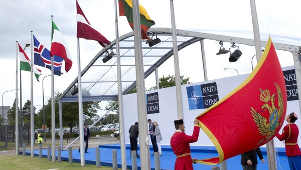 Soldiers from Montenegro unfurl the national flag during a ceremony to mark the accession of Montenegro at NATO Headquarters in Brussels on Wednesday, June 7, 2017 - Sputnik International