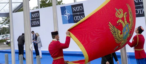 Soldiers from Montenegro unfurl the national flag during a ceremony to mark the accession of Montenegro at NATO Headquarters in Brussels on Wednesday, June 7, 2017 Soldiers from Montenegro unfurl the national flag during a ceremony to mark the accession of Montenegro at NATO Headquarters in Brussels on Wednesday, June 7, 2017 - Sputnik International