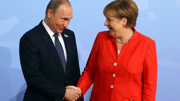 German Chancellor Angela Merkel greets Russian President Vladimir Putin as he arrives for the G20 leaders' summit in Hamburg, Germany July 7, 2017 (File photo). - Sputnik International