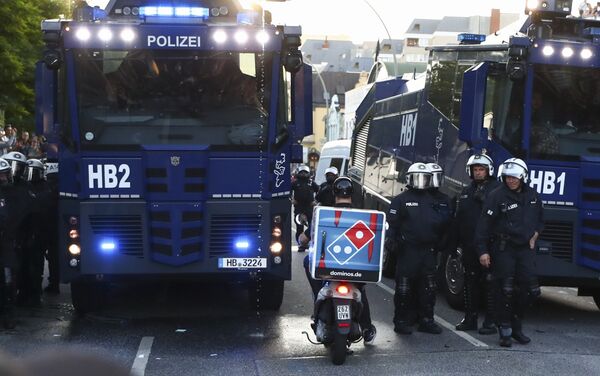 A food delivery driver tries to pass a riot police street blockade during the G20 summit in Hamburg, Germany, July 6, 2017 - Sputnik International
