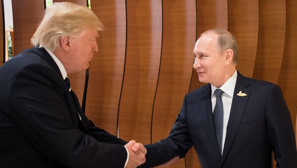 U.S. President Donald Trump and Russia's President Vladimir Putin shake hands during the G20 Summit in Hamburg, Germany in this still image taken from video, July 7, 2017 - Sputnik International