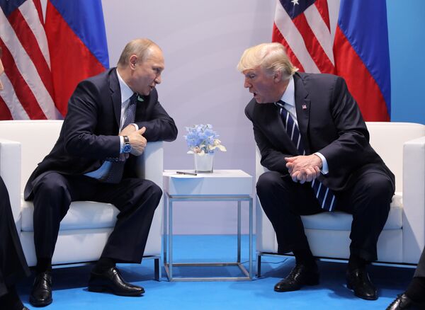 U.S. President Donald Trump speaks with Russian President Vladimir Putin during the their bilateral meeting at the G20 summit in Hamburg, Germany July 7, 2017 - Sputnik International