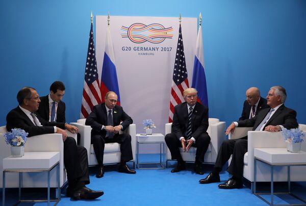 Russia's President Vladimir Putin sits next to U.S. President Donald Trump during their bilateral meeting at the G20 summit in Hamburg, Germany July 7, 2017 - Sputnik International