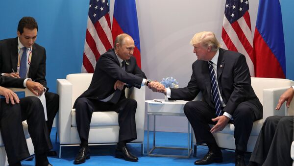 Russian President Vladimir Putin and President of the USA Donald Trump, right, talk during their meeting on the sidelines of the G20 summit in Hamburg - Sputnik International