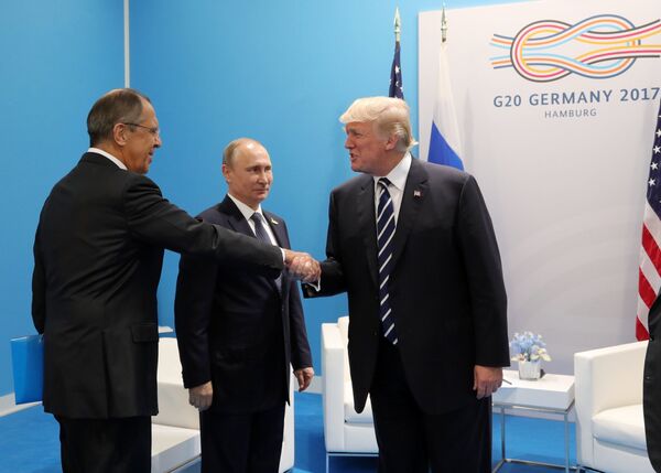 Russian President Vladimir Putin and President of the USA Donald Trump, right, talk during their meeting on the sidelines of the G20 summit in Hamburg. Left: Russian Foreign Minister Sergei Lavrov. Russian President Vladimir Putin and President of the USA Donald Trump, right, talk during their meeting on the sidelines of the G20 summit in Hamburg. Left: Russian Foreign Minister Sergei Lavrov. - Sputnik International