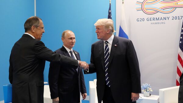 Russian President Vladimir Putin and President of the USA Donald Trump, right, talk during their meeting on the sidelines of the G20 summit in Hamburg. Left: Russian Foreign Minister Sergei Lavrov. - Sputnik International