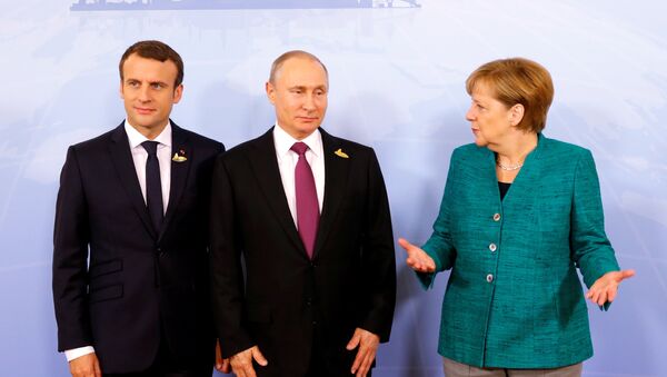German Chancellor Angela Merkel, Russian President Vladimir Putin and French President Emmanuel Macron meet during the G20 leaders summit in Hamburg, Germany July 8, 2017 - Sputnik International