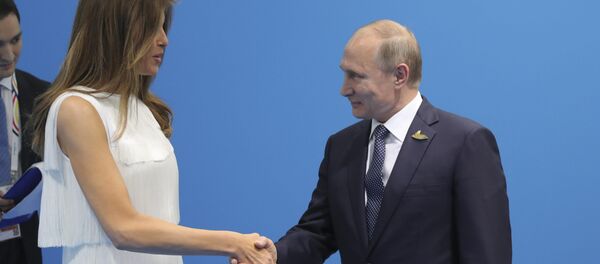 Russian President Vladimir Putin (R) shakes hands with U.S. First Lady Melania Trump during a meeting on the sidelines of the G20 summit in Hamburg, Germany July 7, 2017 - Sputnik International