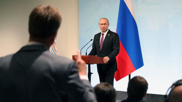 Russian President Vladimir Putin answers journalists' questions during a news conference summing up the results of the G20 summit in Hamburg - Sputnik International