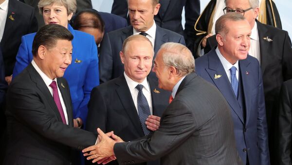 July 7, 2017. Russian President Vladimir Putin during a group photo session of the G20 heads of state, invited countries and international organizations in Hamburg. At left in the foreground: Chinese President Xi Jinping; right: President of Turkey Recep Tayyip Erdogan - Sputnik International