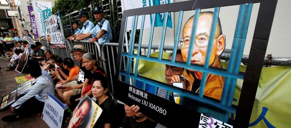 Pro-democracy activists stage a sit-in protest demanding the release of Nobel laureate Liu Xiaobo, outside China's Liaison Office in Hong Kong, China July 10, 2017. Pro-democracy activists stage a sit-in protest demanding the release of Nobel laureate Liu Xiaobo, outside China's Liaison Office in Hong Kong, China July 10, 2017. - Sputnik International