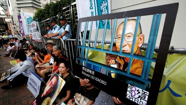Pro-democracy activists stage a sit-in protest demanding the release of Nobel laureate Liu Xiaobo, outside China's Liaison Office in Hong Kong, China July 10, 2017. - Sputnik International