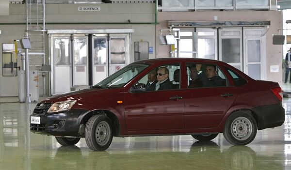 Russian Prime Minister Vladimir Putin, left, takes the Lada Kalina model-based new Lada-Granta car for a drive at AvtoVAZ plant in Togliatti. May 11, 2011. Russian Prime Minister Vladimir Putin, left, takes the Lada Kalina model-based new Lada-Granta car for a drive at AvtoVAZ plant in Togliatti. May 11, 2011. - Sputnik International